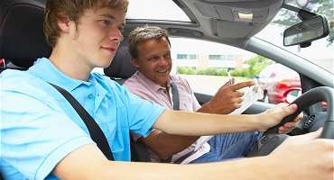 Young male driver with driving instructor 